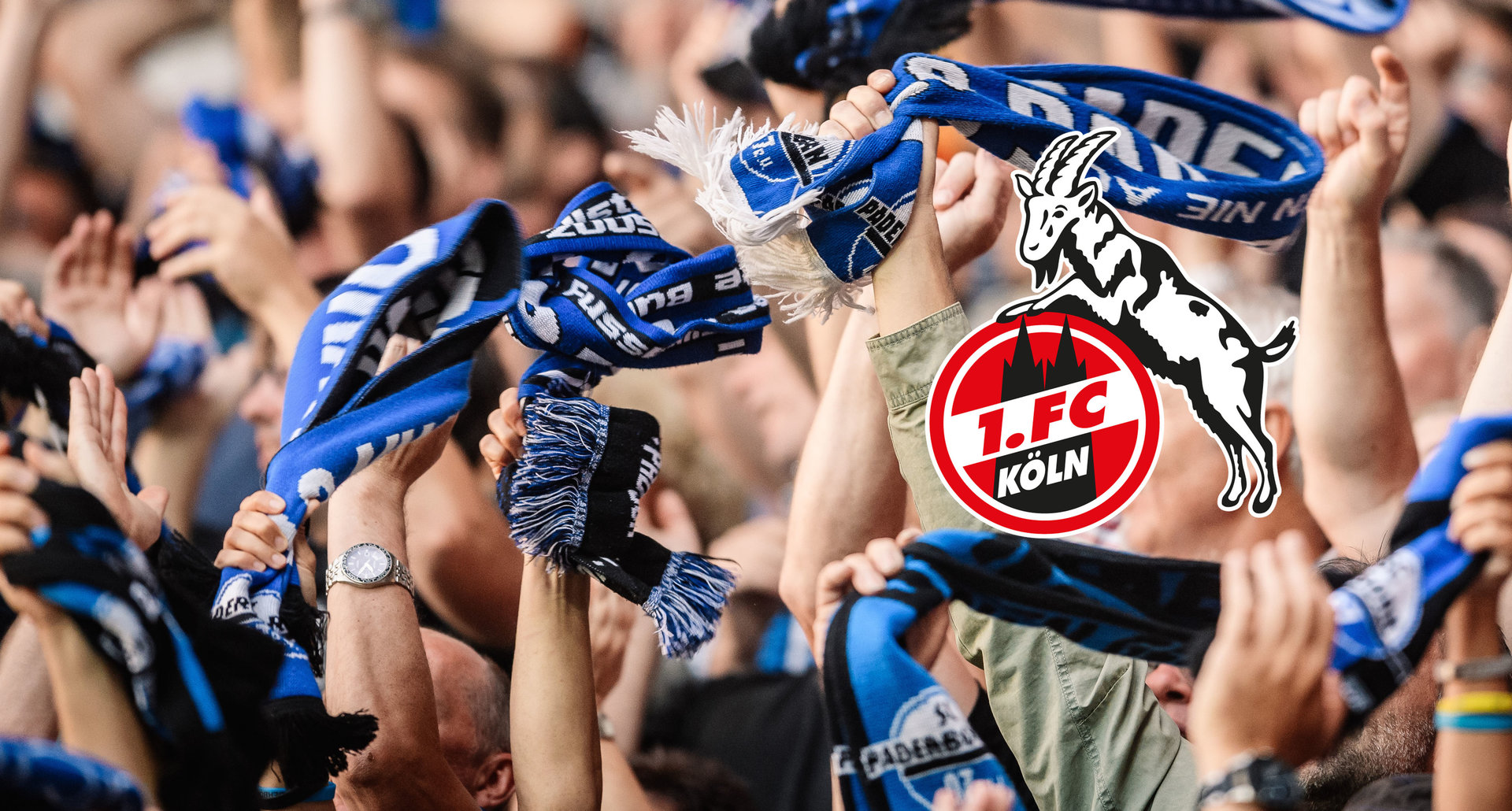 Fans auf der Südtribüne heben ihre SCP07-Schals in die Höhe, Logo 1. FC Köln
