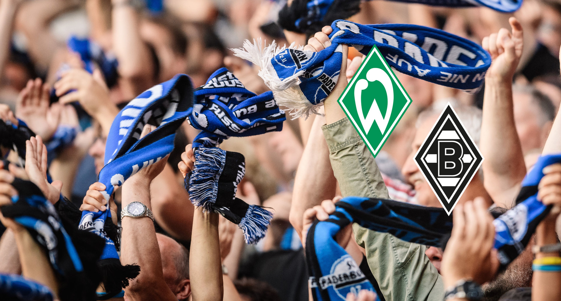 Fans auf der Südtribüne halten ihre Fanschals hoch, im Vordergrund: Logo SV Werder Bremen + Logo Borussia Mönchengladbach